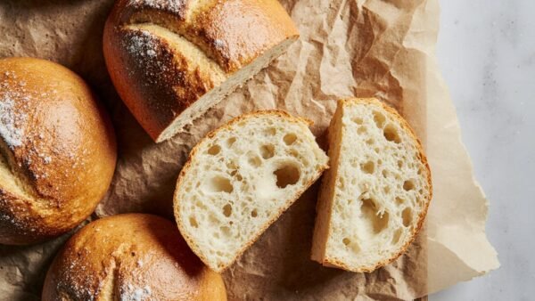 Mini sourdough boules baked until golden brown with a crusty exterior.